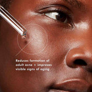 Close-up of a person's eye with a dropper applying a product, text indicating benefits on skin.