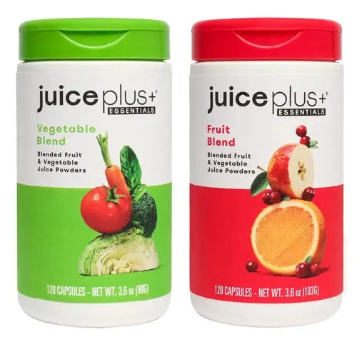 Two containers of Juice Plus+ supplement, one labeled 'Vegetable Blend' green cap, other 'Fruit Blend' red cap, both showing various fruits and vegetables on the labels.