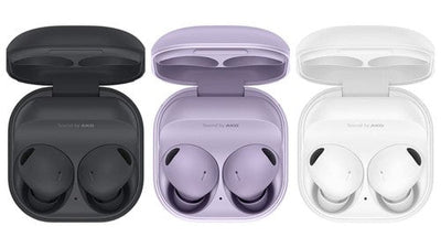 Three pairs of wireless earbuds in open cases on a white background